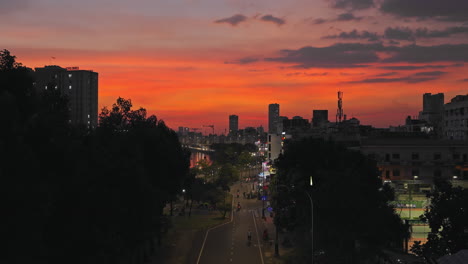 Aerial-view-of-city-under-orange-sunset-sky