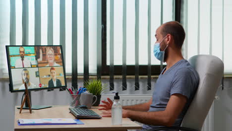 man having video call with remote team