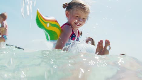 water fun. extended family with kids swim in the warm calm sea and have fun together