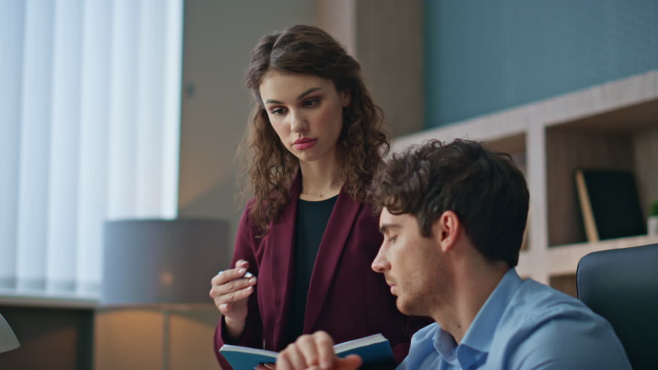 Businessman talking woman assistant working together in corporate office closeup