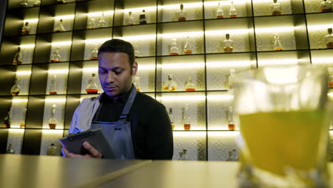 bartender writing on clipboard