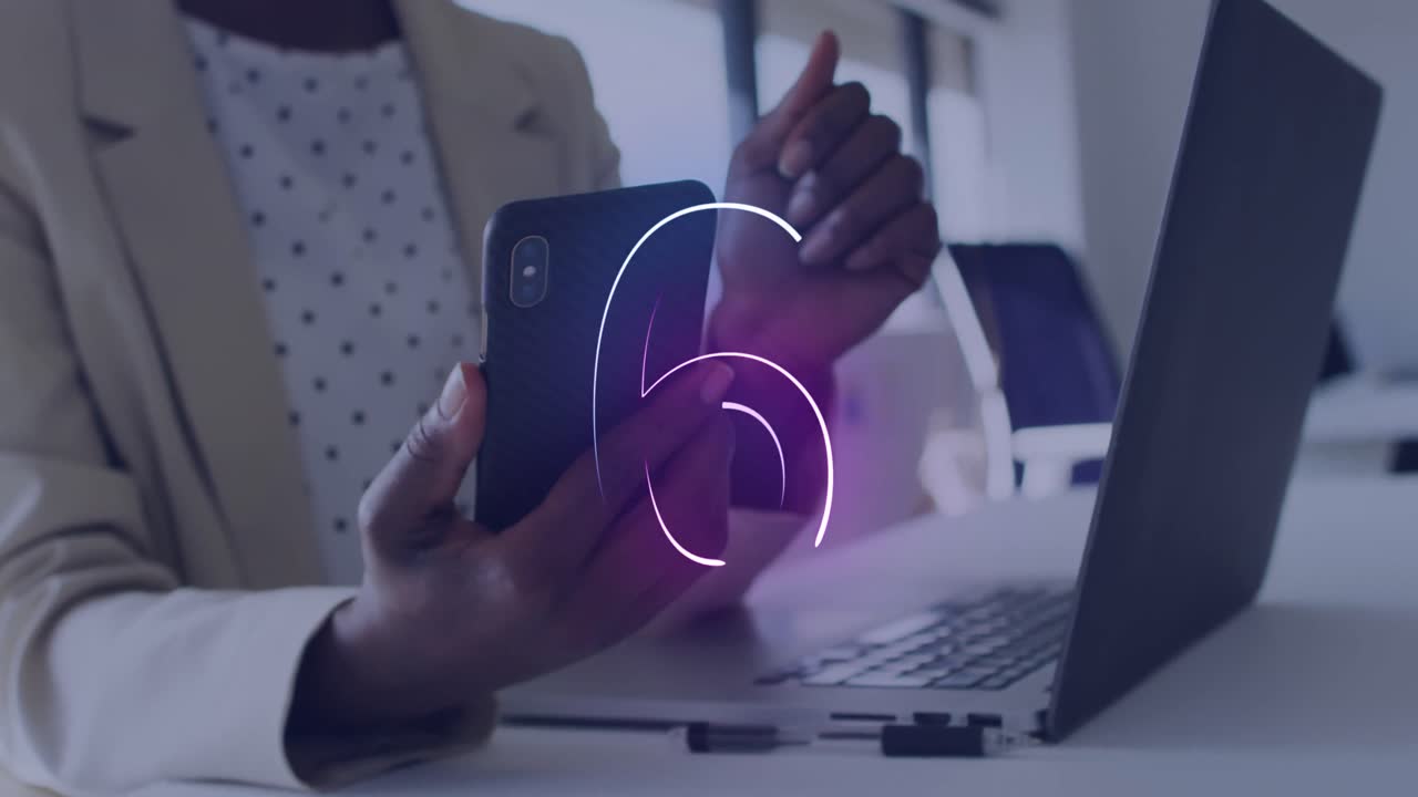 Animation of countdown over mid section of african american businesswoman using smartphone at office