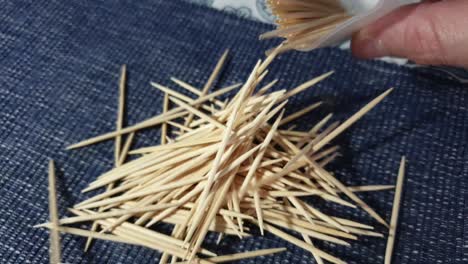 not struggling to select one pointy wooden toothpick out of the case, just throw a bunch out on the table out of frustration with hand