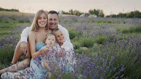 portrait of a young happy family on a lavender field.