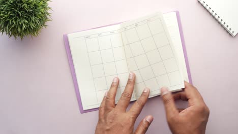 weekly planner and notepad on table