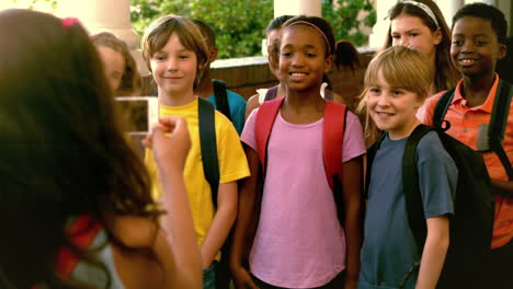 Cute-pupil-taking-a-photo-of-her-classmates