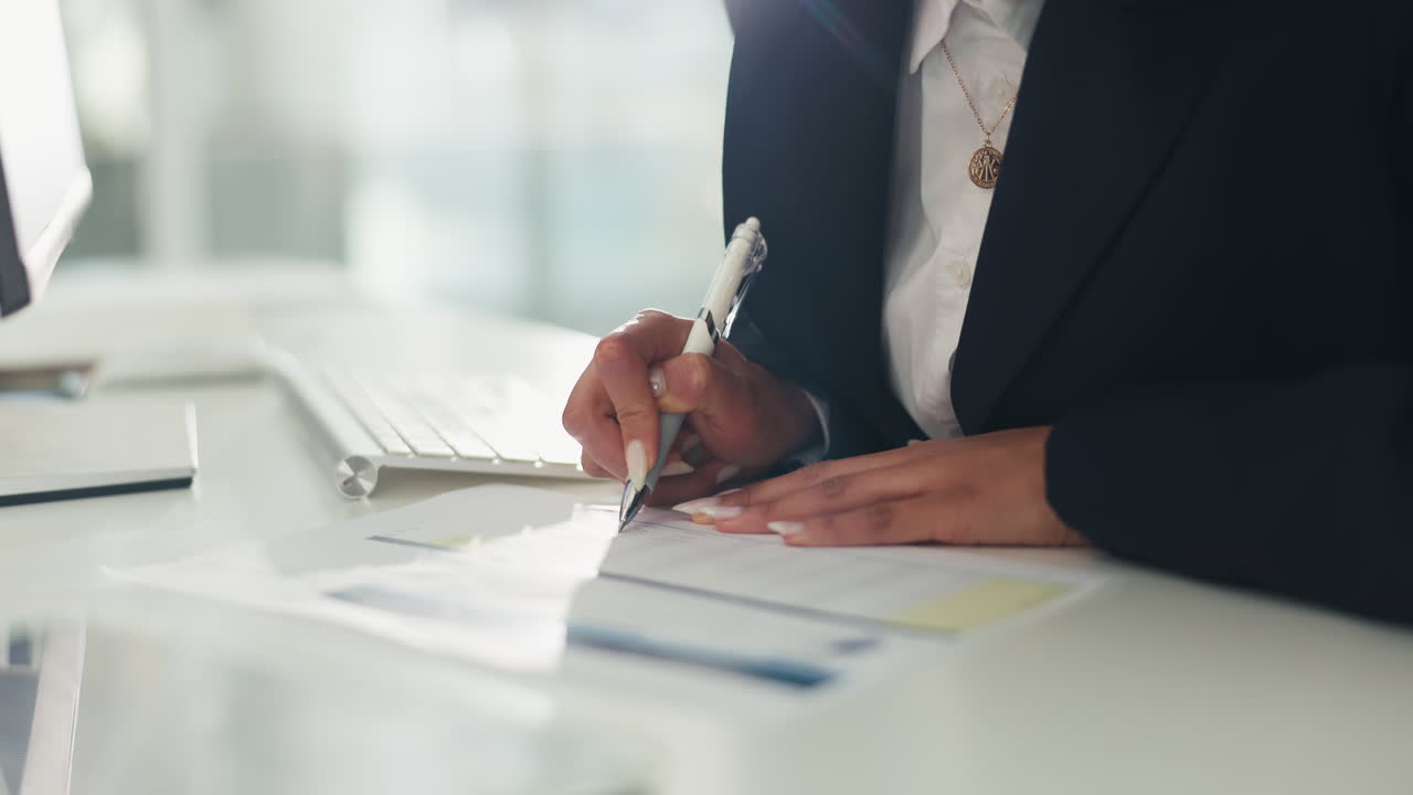 Businesswoman signing a document in the office