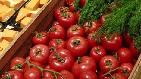 fresh red tomatoes and dill in wooden crate