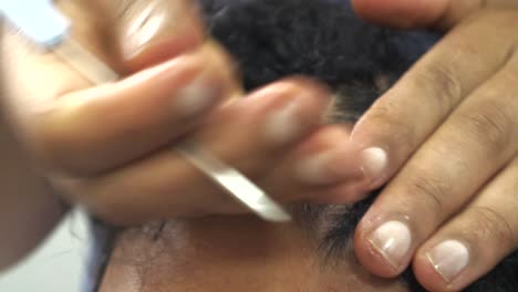 close shot for girl doing man hair in ethiopian style