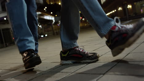 Closeup-man-and-woman-legs-dancing-on-street.-Unknown-couple-jumping-outdoor.