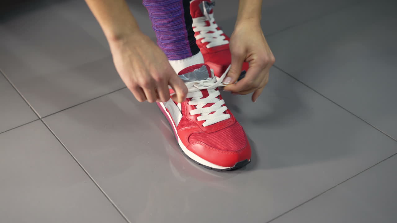 Athlete tying shoelaces before training