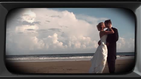 animation of happy couple on wedding day at beach on retro tv screen