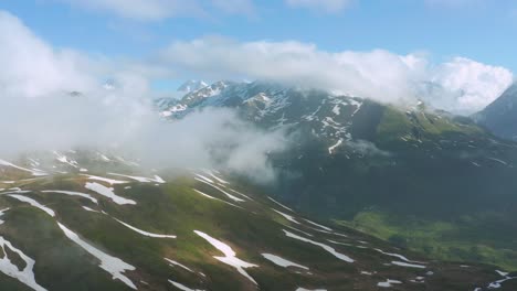 Flauschige-Wolkengebilde-Am-Alpenberg-Unter-Blauem-Himmel