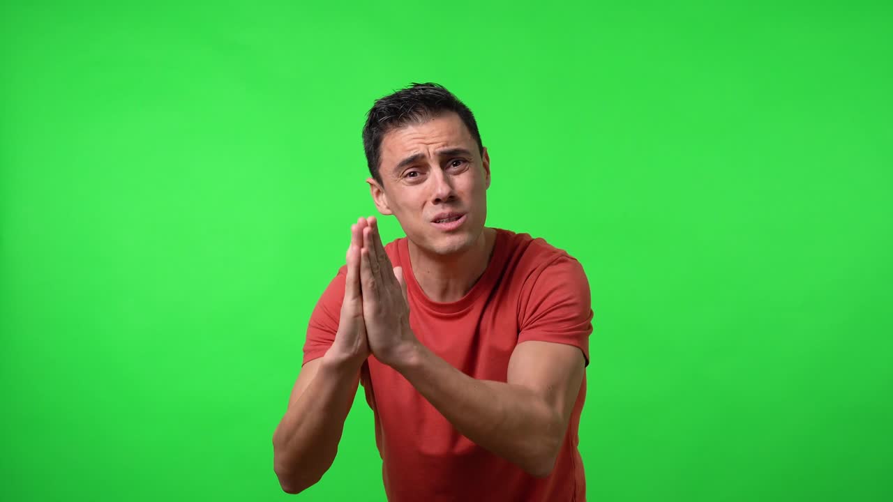 Man desperately begging for something. With a red shirt.
