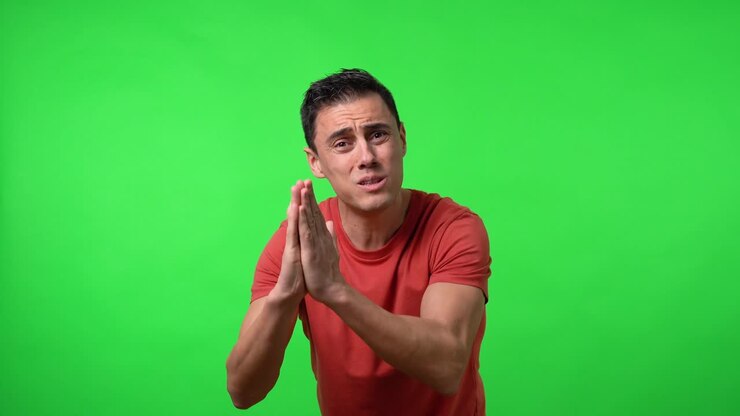 Man desperately begging for something. With a red shirt.