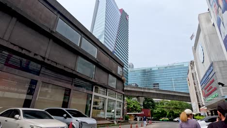 people walking near buildings and vehicles