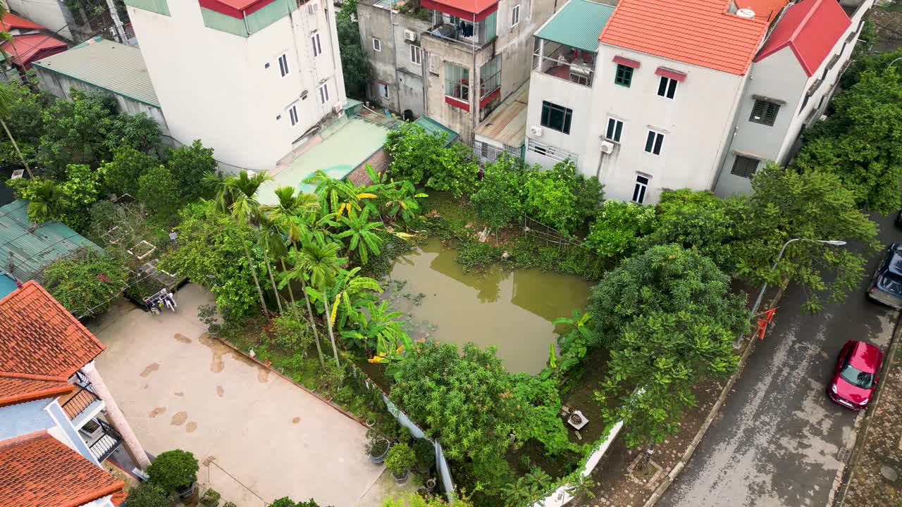 Drone fly residential buildings at tropical area of Hanoi City, Vietnam streets