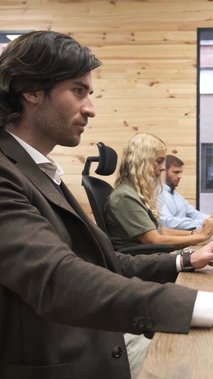 Businessman slowly turning head in office. Vertical footage