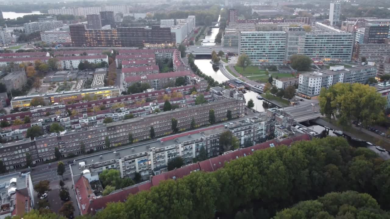네덜란드 암스테르담에서 멀어지는 공중 전망을 통해 운하와 전형적인 주택의 건축 양식을 볼 수 있습니다.