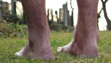 standing barefoot in wet grass at sunset