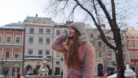 Portrait-of-young-female-girl-tourist-looking-around,-walking-alone-through-street-in-old-town