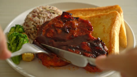 slicing-barbecue-pork-steak-on-plate