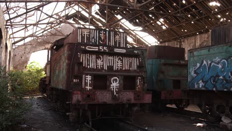 grafitti on abandoned rusty trains in ancient train station on the edge of tripoli, northern lebanon