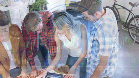 Spinning-globe-against-group-of-diverse-office-colleagues-discussing-together-at-office