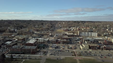 aerial dolly right, city of stillwater downtown in fall with blue sky