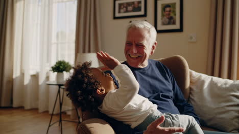 joyful grandfather and grandchild playful moments at home