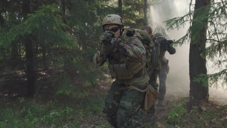 soldiers walking through smoke in forest