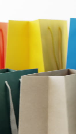 multicolored shopping bags on white background