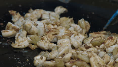 cooking fried squid on a hot plate
