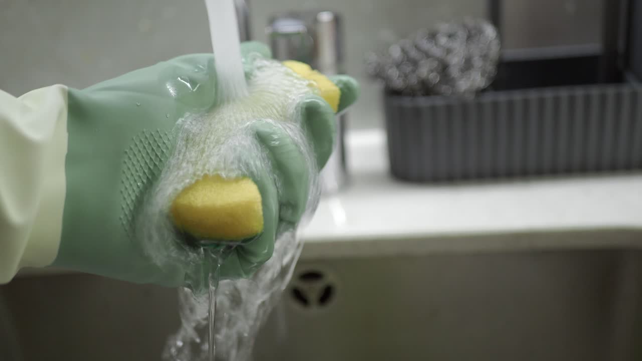 Washing a Dish Sponge in the Sink