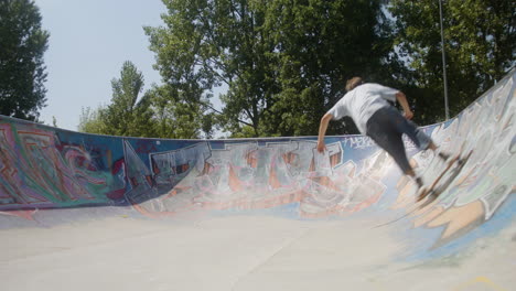 caucasian boy skateboarding in the park.