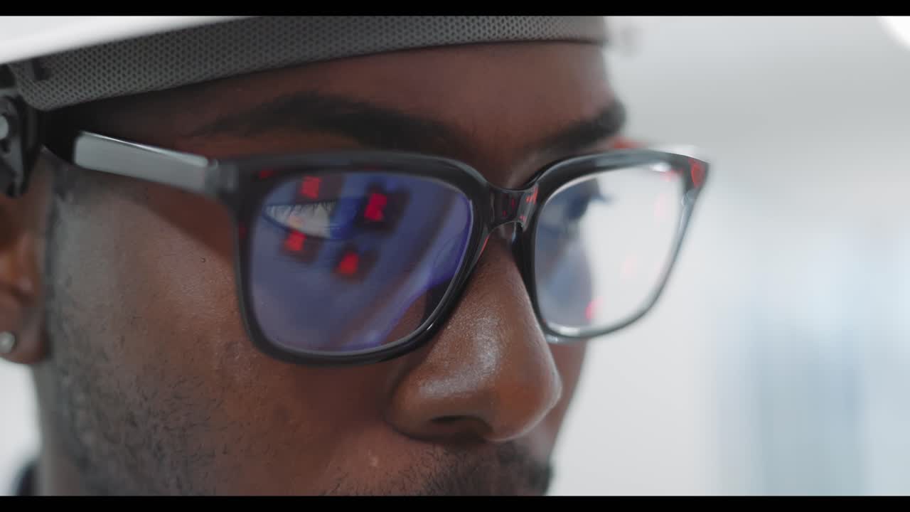 Closeup of a person wearing safety glasses and hardhat