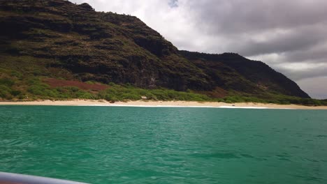 gimbal wide panning shot from a boat along the rugged southern na pali coastline near polihale beach on the hawaiian island of kaua'i