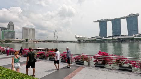 pedestrians strolling along a scenic waterfront promenade.