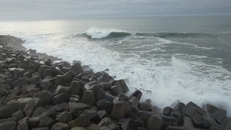 sea waves explode on the rocky shore