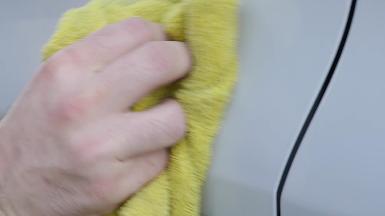 Removing spot of tar from white car with yellow cloth