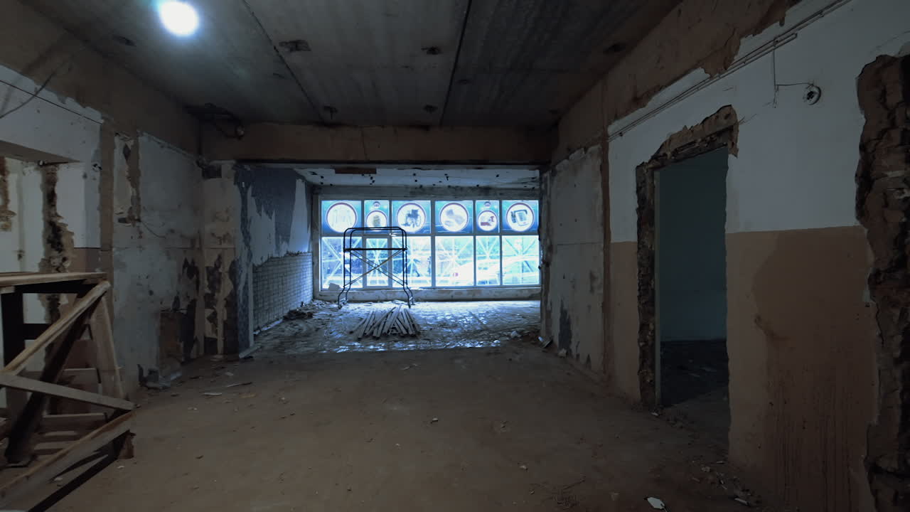 Walking by the old shabby premise with no doors inside. Reconstruction process of a building.