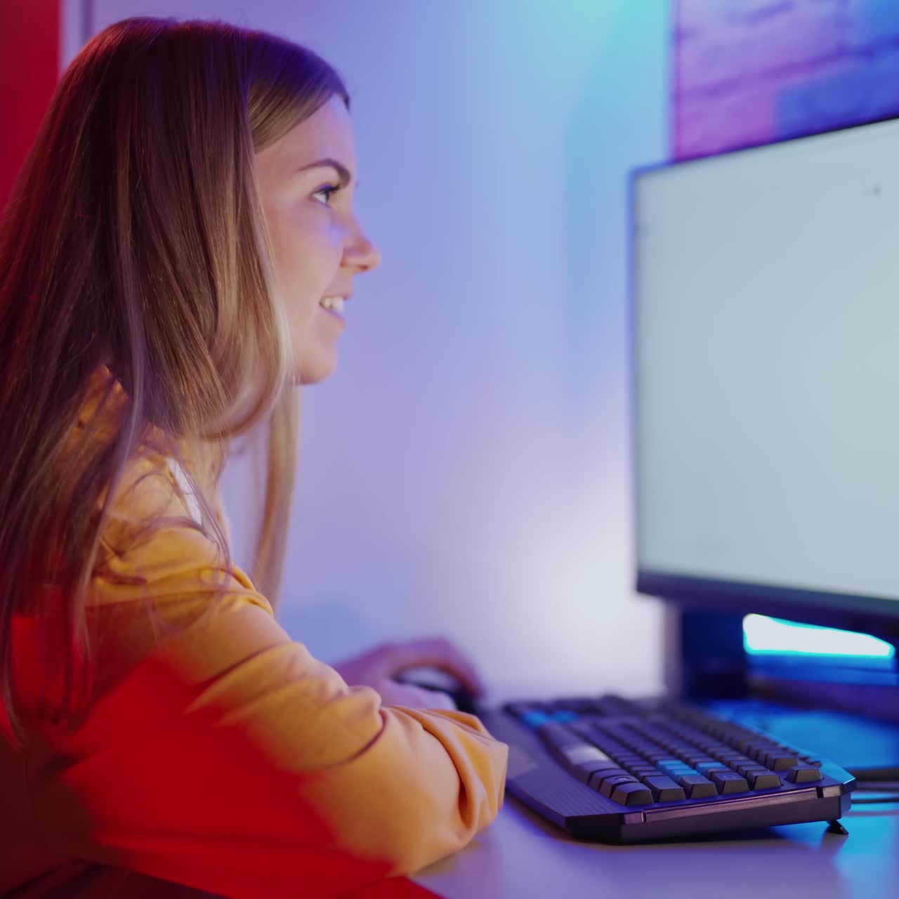 Happy woman looking on screen with many pictures. Beautiful girl sitting at home in front of the computer and laughing.