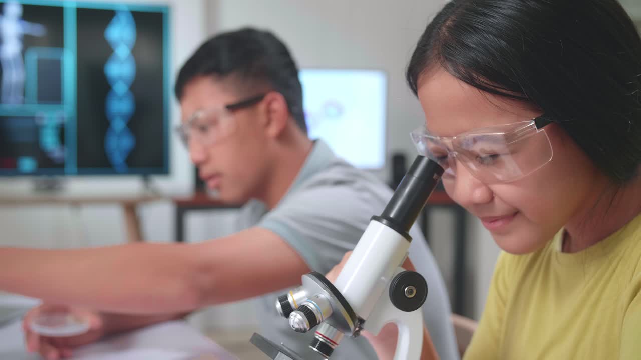 Young Asian Boy And Girl Learning Science Experiment In Laboratory At Classroom. Study With Scientific Equipment And A Microscope