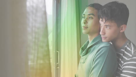 Embracing-by-window,-couple-with-rainbow-light-animation