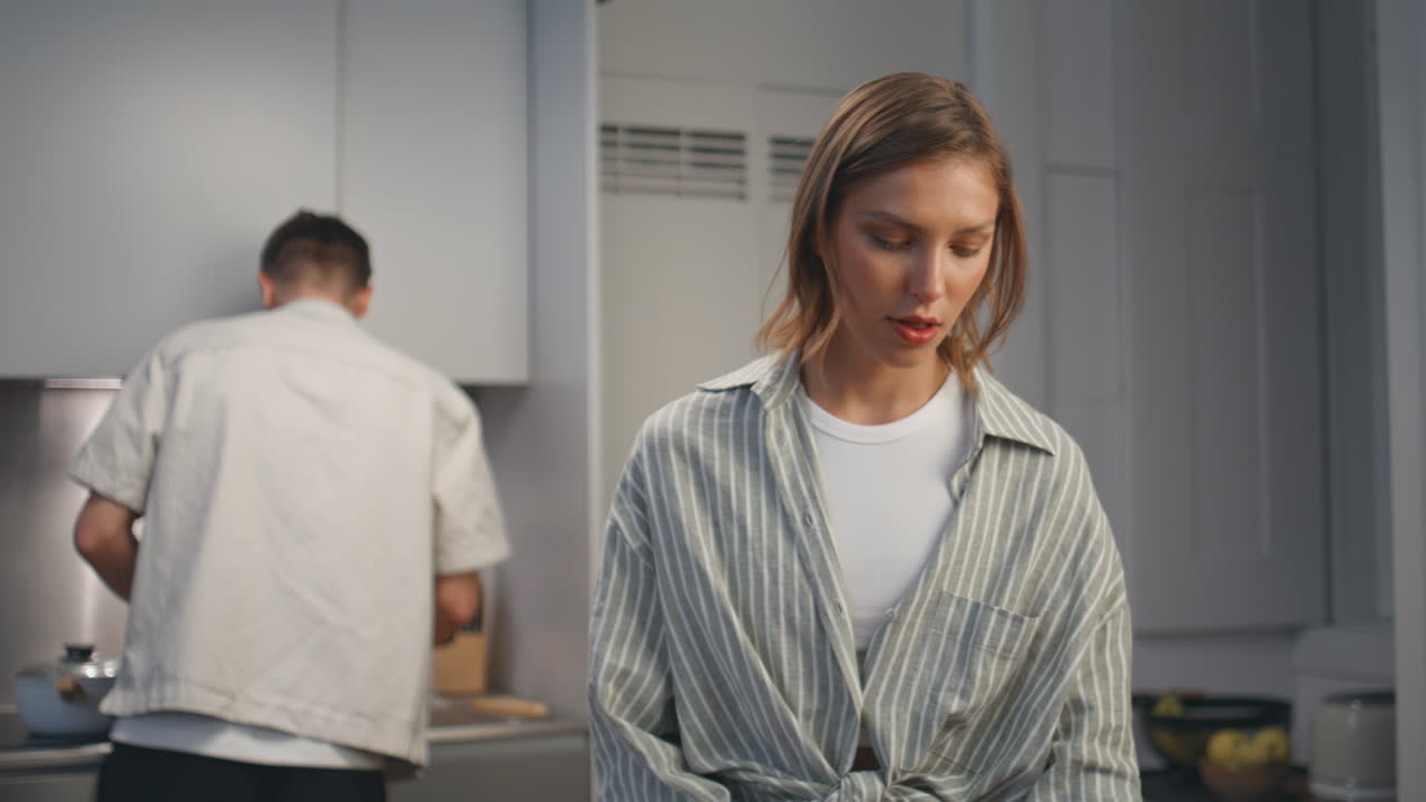 Girlfriend cutting salad vegetables in kitchen. Married couple preparing dinner