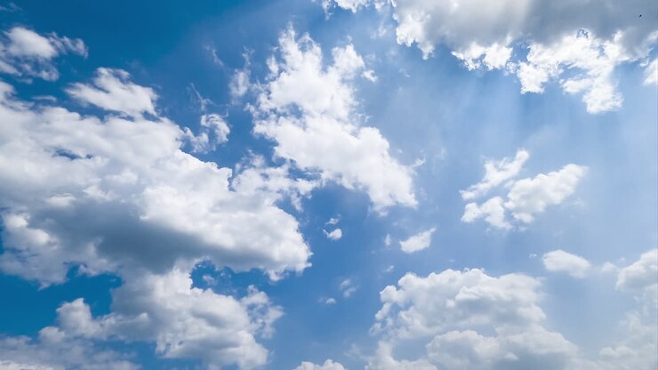 Building cloudscape on beautiful bright summer day. Light cotton clouds in the beams of sun timelapse.
