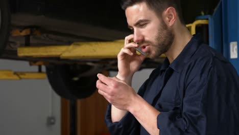 Handsome-mechanic-on-a-phone-call