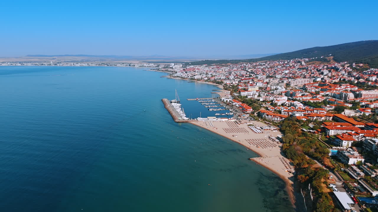 Aerial view of Sveti Vlas coastline in Bulgaria. A scenic aerial view of Sveti Vlas coastline with beaches, marina, and residential buildings along the Black Sea in Bulgaria
