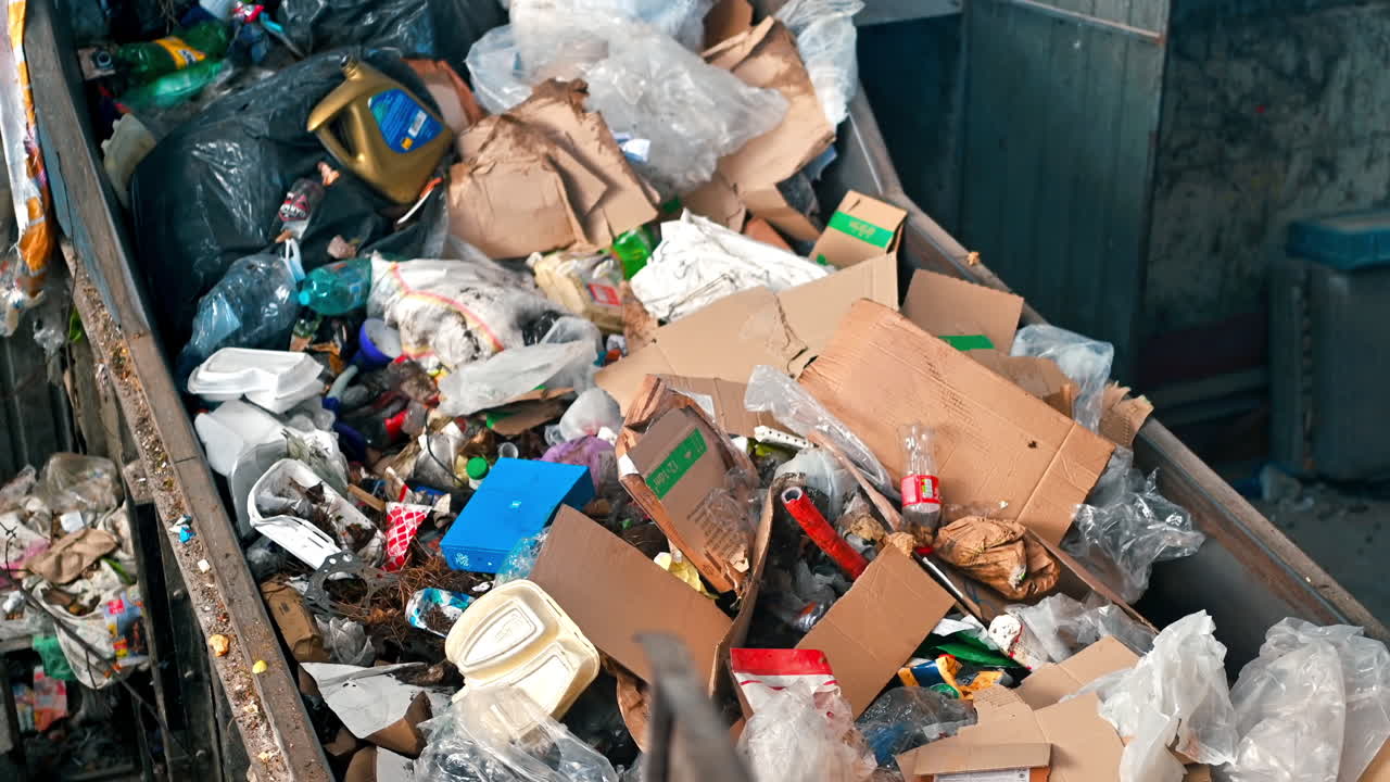 Garbage moving on a conveyor belt at waste sorting plant. Slow motion