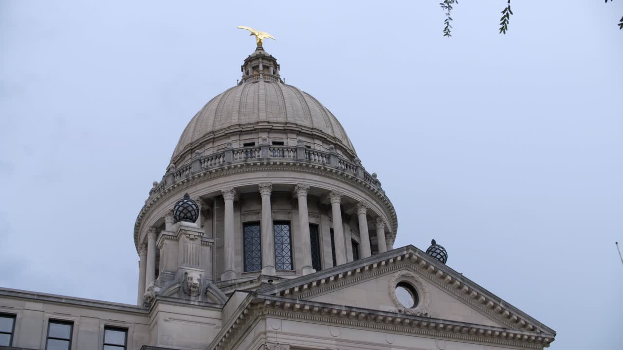 Close up, dome and roof: Stormy skies over the Mississippi State Capitol building. Jackson, MS